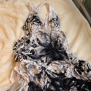 Chic black & white print dress with a halter neckline & beautiful rhinestones.